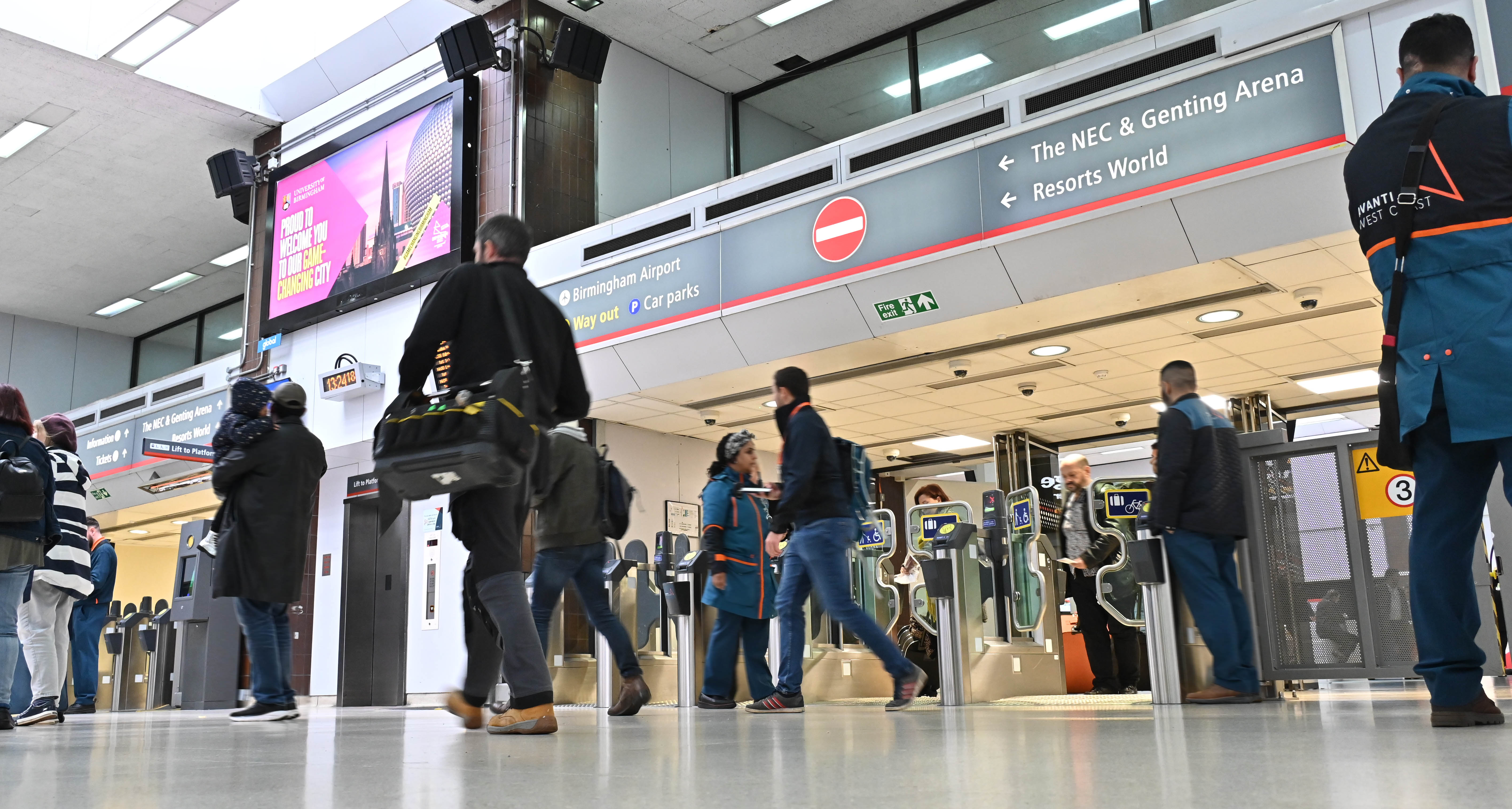 People walking through Birmingham International Rail Station